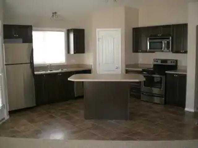 1 Bedroom + Den Luxurious 12 plex village home in Panorama Hills