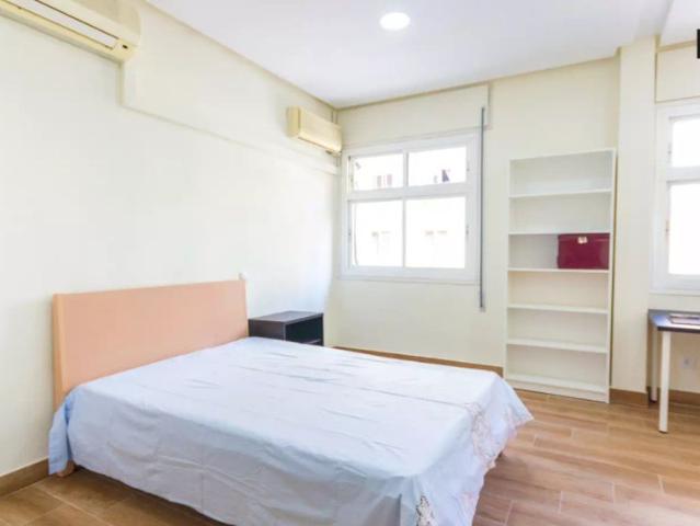 Welcoming room with window with street view in shared apartment, Moncloa
