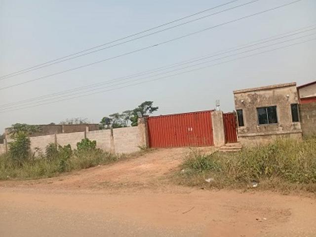 A commercial premise comprising OC factory block, office block, staff quarters, gate house, transformer block and 2No storage tank stand