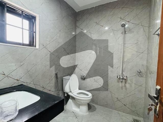 2 kanal beautiful barand new house top location excellent washrooms modren feting and fixtures 11 bed rooms green lawn f 10
