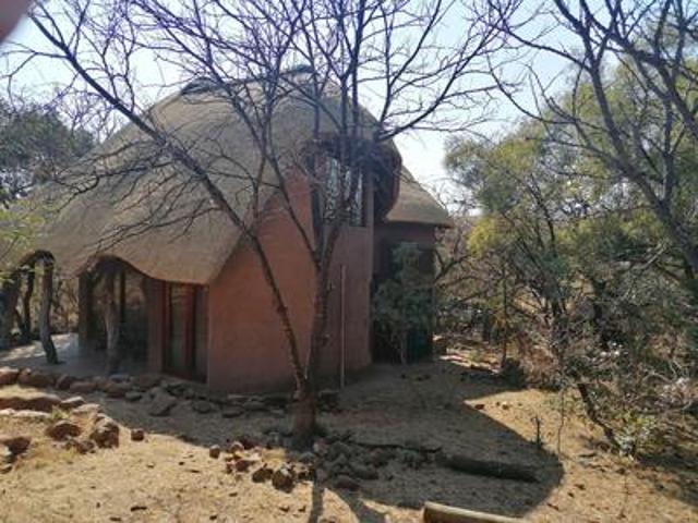 beautiful thatch roof house with a t.