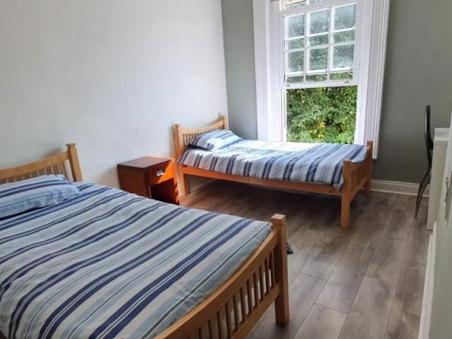 Bed in a bright twin room in Broadstone