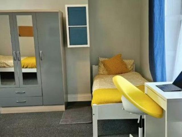 Bed in a colourful twin bedroo, in Broadstone