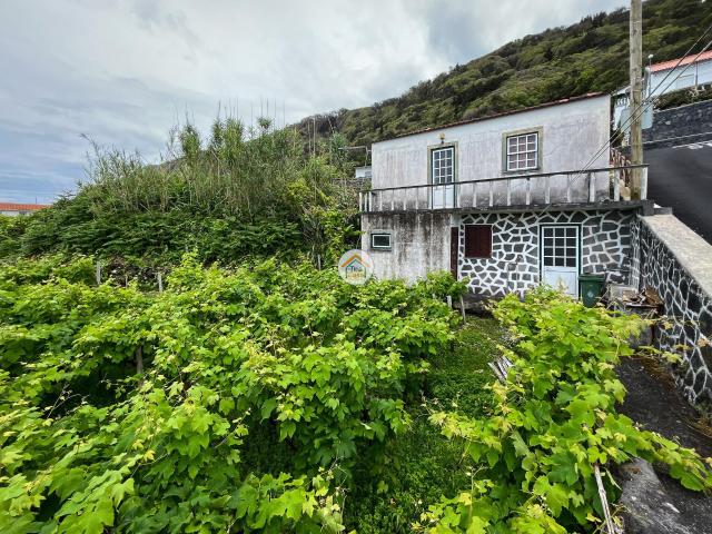 Casa de rés do chão e 1º andar destinada a habitação e quintal Fajã do Ouvidor. Ilha de São Jorge
