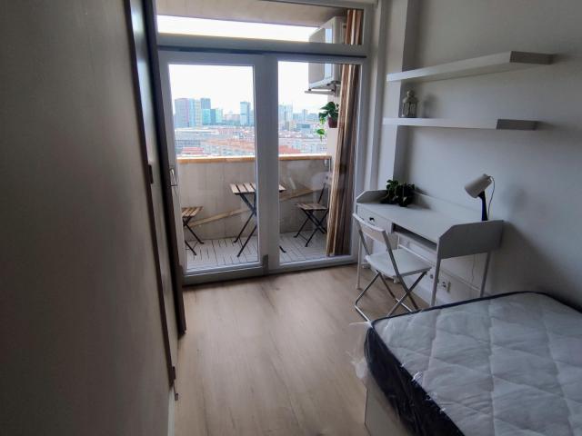 Cozy bedroom with a balcony in co living