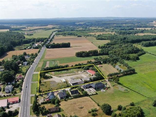 Działka inwestycyjna 12 000 m² z magazynami, blisko drogi