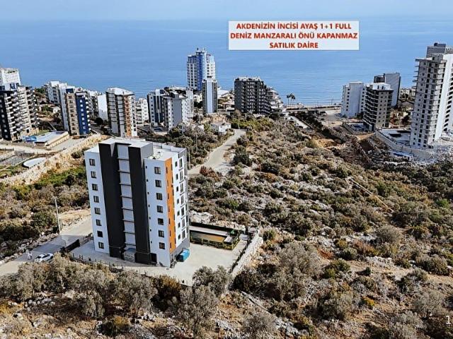 ERDEMLİ AYAŞ DENİZ MANZARALI 1+1 EŞYALI KÖŞE DAİRE ÖNÜ KAPANMAZ