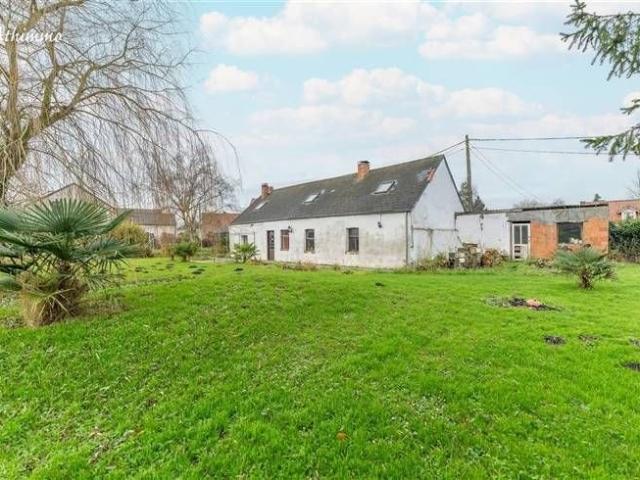 Fermette basse sur son beau jardin avec deux passages latéra