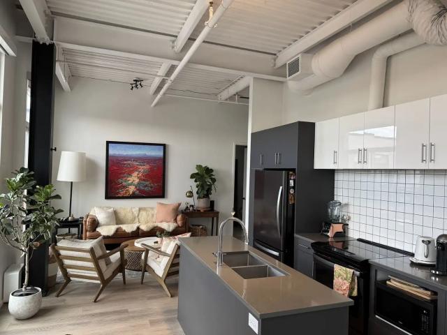 Floor to ceiling windows + two balconies + sunny penthouse apartment
