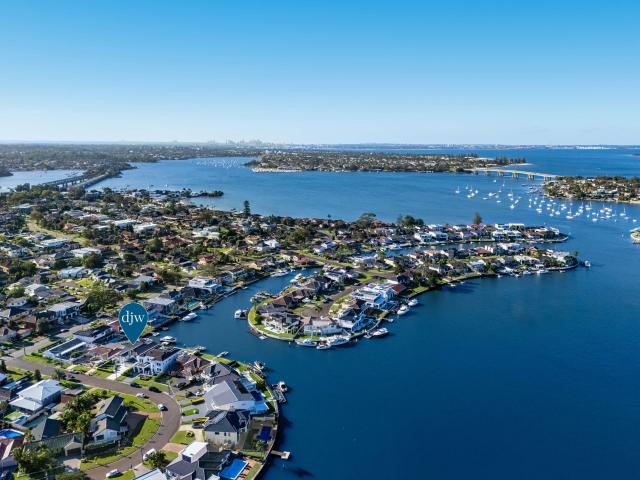 Luxury deep waterfront with stunning 180 degree views in highly coveted sought after street