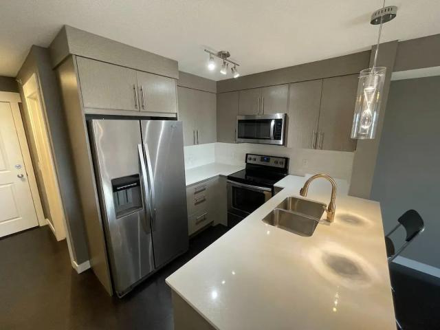 Modern + Bright TOP FLOOR Condo with a view!
