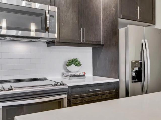 New condition top floor 1 bedroom and den with underground parking and storage