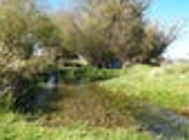Sheds, A Stream & Mountain Views