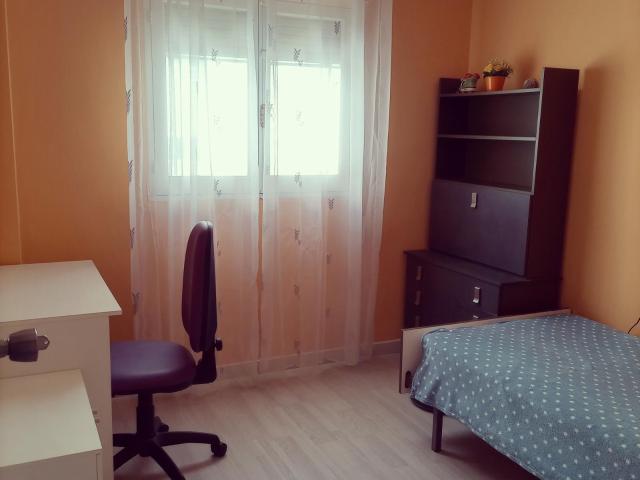 Single bedroom with desk and TV