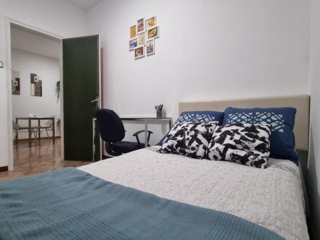 Single bedroom with interior window in 5 bedroom apartment