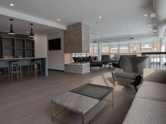 Steps to the Lyon O Train Station: Building amenities include a gym, party room, lounge, and rooftop patio
